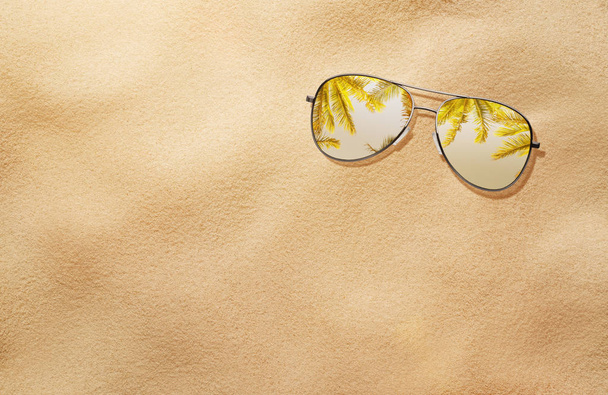 High angle view of sunglasses in the sand - Фото, зображення
