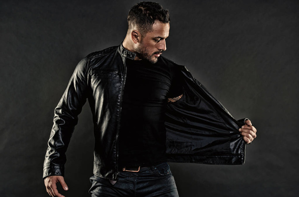 Style and trend. Bearded man undress leather jacket. Man with beard on unshaven face. Fashion model in casual style clothes. Mens sexuality or attraction and charisma in vintage filter - Foto, afbeelding