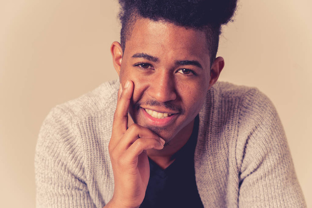 Portrait of young attractive stylish african american teenager man model posing in casual clothes against neutral background looking sexy with afro hair. In People Youth Beauty and fashion concept. - 写真・画像
