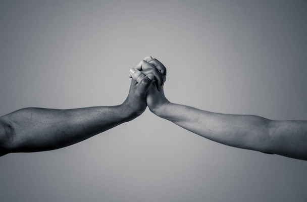 Black African American and Caucasian hands holding together stop racism. White and black skin arms in world unity multiracial love and understanding in tolerance and races diversity cooperation. - Fotografie, Obrázek