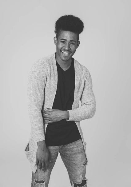 Portrait of attractive stylish young african american teenager man posing happy looking at the camera with fashion and stylish clothes and afro hairstyle. In People beauty and youth fashion trends. - Foto, Imagen