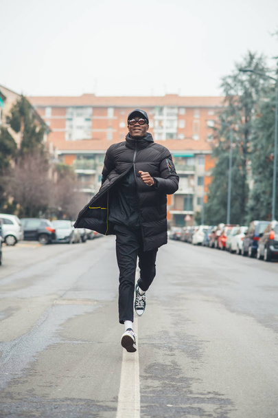 young black man running in the street and looking further  - Fotó, kép