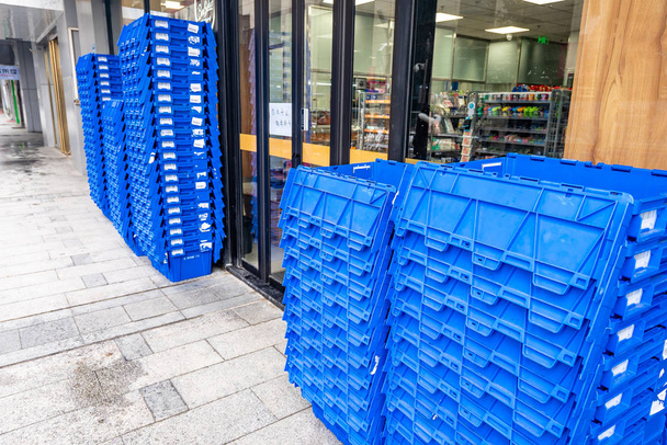 stacks of blue plastic containers for storage in store  - Fotografie, Obrázek