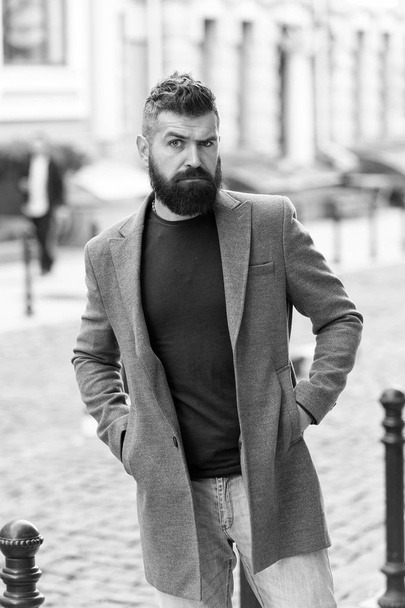 Man bearded hipster casual style waiting for taxi. Guy at street city center. Looking for transportation. Bus stop. Taxi please. Businessman catching taxi while standing outdoors urban background - Photo, Image