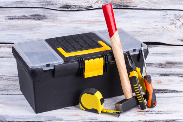 Tool box and different tools on wooden background. - Photo, Image