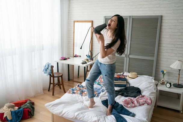 girl having fun with tools dancing indoors - Photo, Image