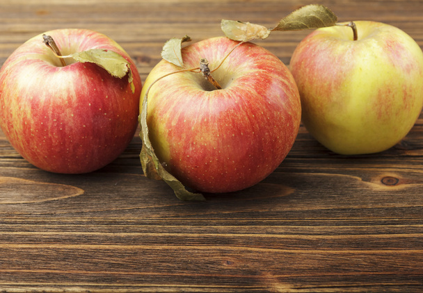 Red apples on wooden table - Φωτογραφία, εικόνα