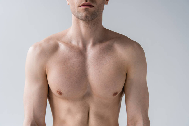 cropped view of shirtless sexy muscular man isolated on grey - Fotografie, Obrázek