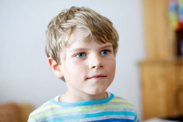 Portrait of little cute school kid boy in colorful clothes. Happy positive child. - Fotografie, Obrázek
