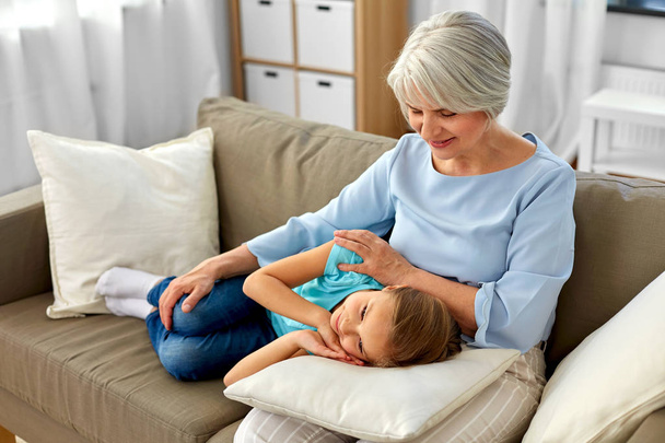 grandmother and granddaughter resting on pillow - Foto, imagen