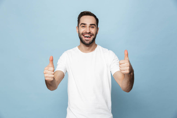 Cheerful excited man wearing blank t-shirt standing - Photo, image
