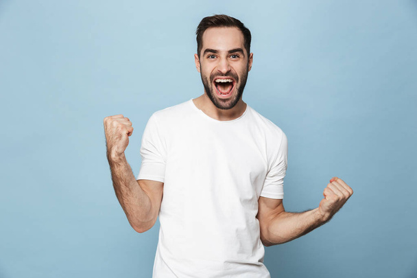 Cheerful excited man wearing blank t-shirt standing - Foto, Imagem