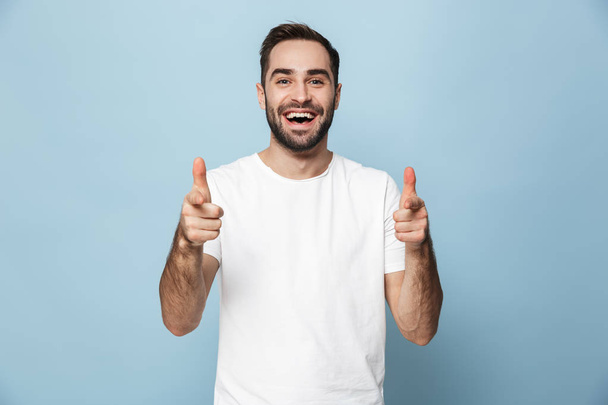 Cheerful excited man wearing blank t-shirt standing - Photo, Image