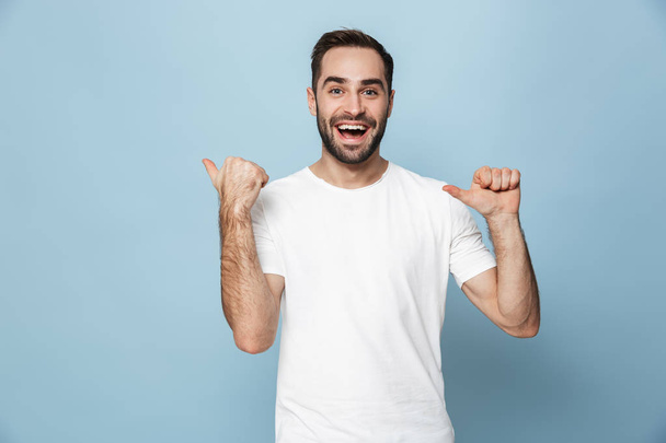 Cheerful excited man wearing blank t-shirt standing - Photo, image