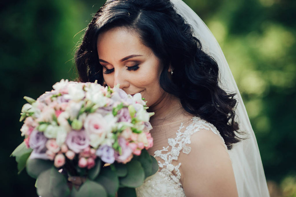 Tender elegant bright posing with fresh wedding bouquet  - Фото, зображення