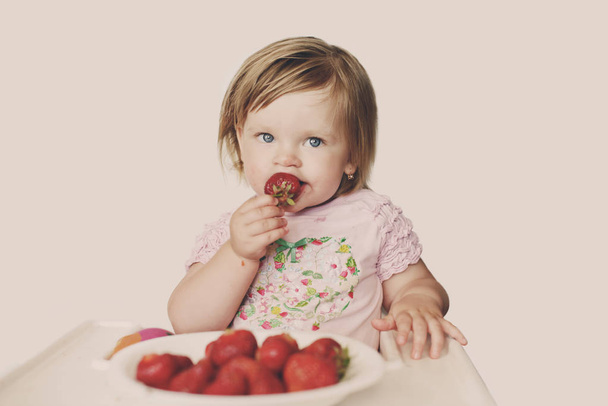  baby  girl   eating strawberry  - Photo, Image