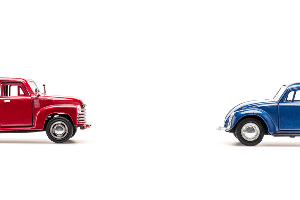 red and blue toy cars on white with copy space - Fotó, kép