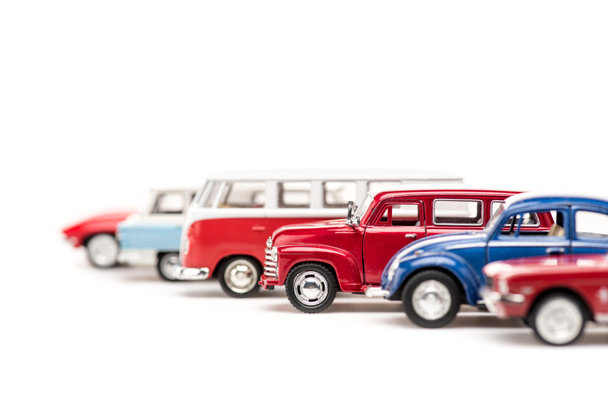 selective focus of colorful toy cars and bus on white - Foto, afbeelding