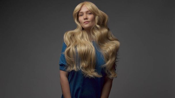 nordic blond model in studio with dramatic top light. Blonde long hair - Фото, изображение