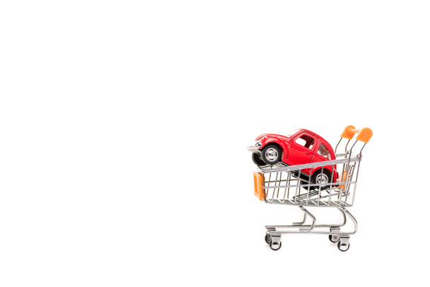 red toy car in shopping cart isolated on white - Φωτογραφία, εικόνα