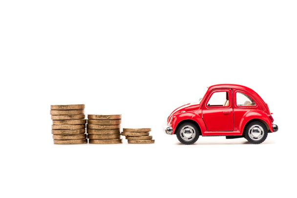 red toy car and golden coins on white - Фото, зображення