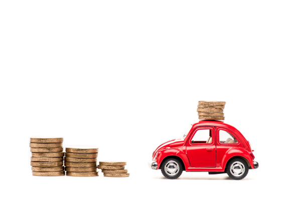 red toy car and golden coins on white - Foto, Bild