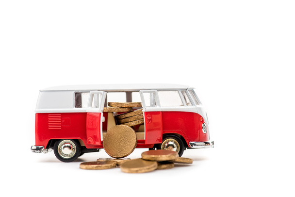 toy bus with golden coins on white with copy space - Φωτογραφία, εικόνα