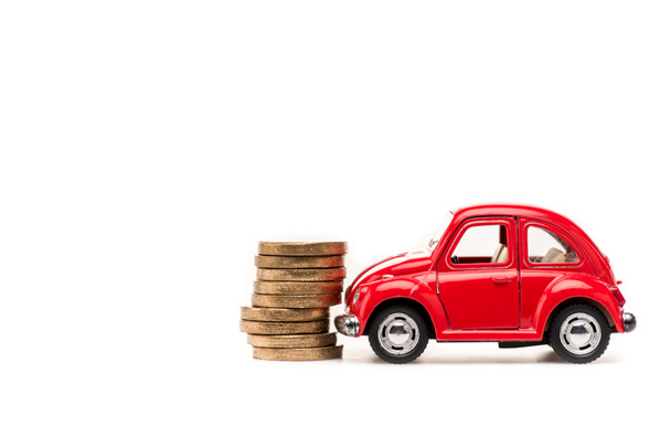 red toy car and golden coins on white - Foto, immagini
