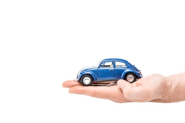 cropped view of man holding blue toy car isolated on white - Fotografie, Obrázek