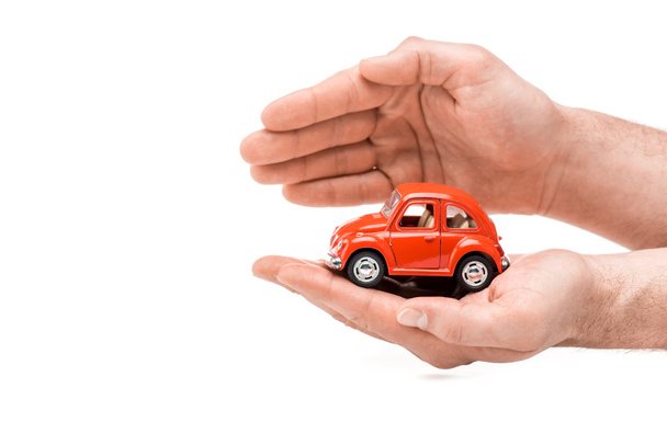 cropped view of man holding red toy car isolated on white - Φωτογραφία, εικόνα