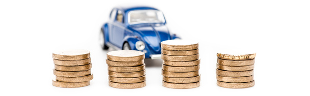 panoramic shot of coins and blue toy car on white - Фото, изображение