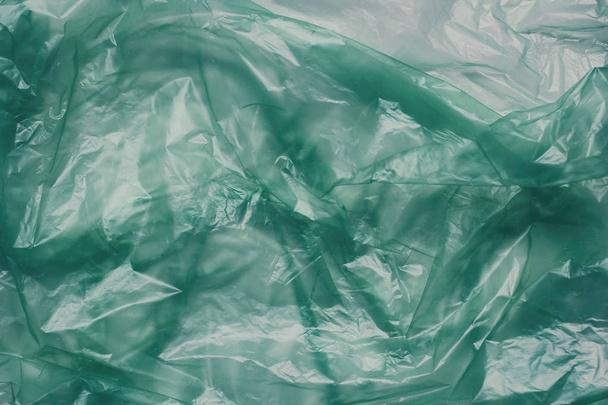 Plastic green bag texture background. Crumpled polyethylene texture. Waste recycle concept.  - Foto, afbeelding