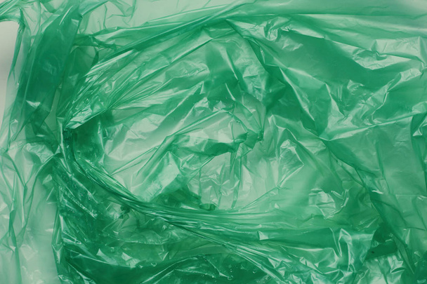 Plastic green bag texture background. Crumpled polyethylene texture. Waste recycle concept.  - Фото, зображення
