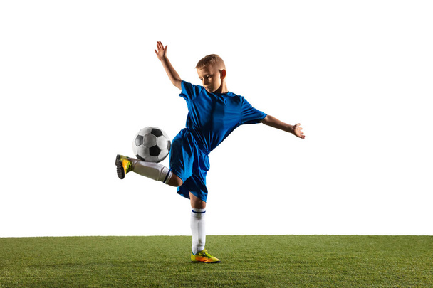 Young boy as a soccer or football player on white studio background - Foto, afbeelding