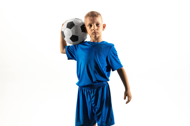 Young boy as a soccer or football player on white studio background - 写真・画像