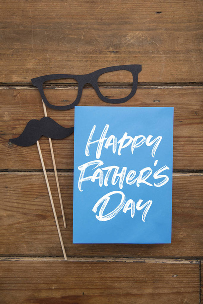 Fathers day card with paper mustache and glasses on sticks - Foto, afbeelding