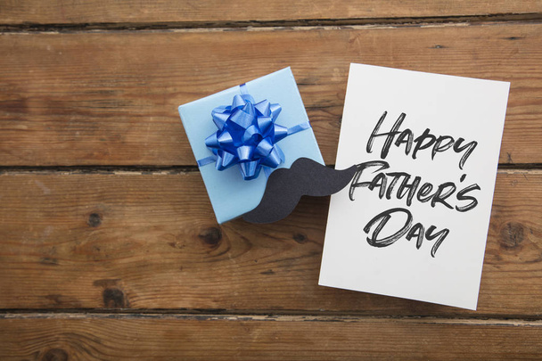 Happy Fathers Day card composition with gift box and mustache - Fotografie, Obrázek