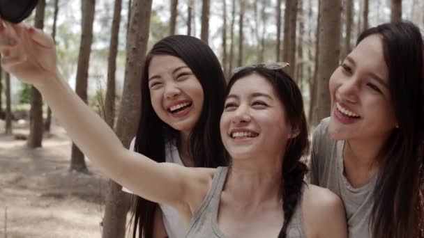 Έφηβος θηλυκό με smartphone βιντεολόγιο βίντεο και ζουν σε κοινωνικά μέσα, ομάδα νεαρών ασιατικών φίλων camping στο δάσος. Δραστηριότητα περιπέτειας και ταξίδι στις διακοπές διακοπών το καλοκαίρι. Βολή αργής κίνησης. - Πλάνα, βίντεο