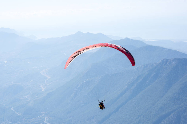 Paraglider flying over mountains - 写真・画像
