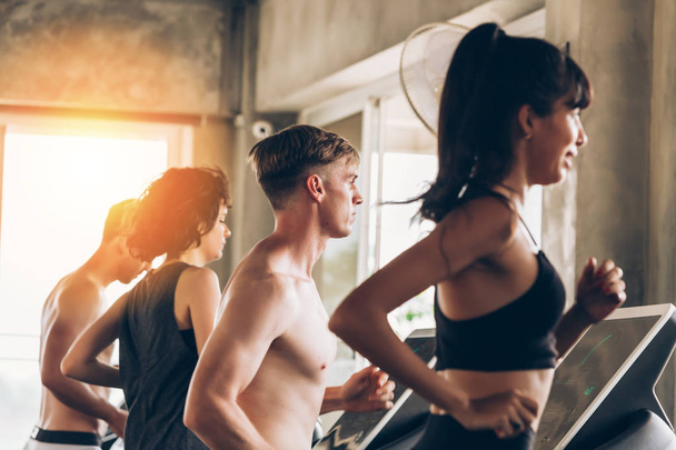 Young Caucasian sporty group of men and women running on treadmill in gym - Fotoğraf, Görsel