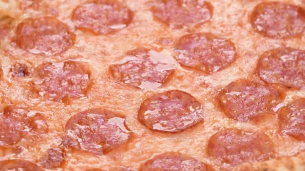Pizza closeup with salami and cheese mozzarella 4k footage. Slow rotation of pepperoni pizza macro detail - Footage, Video