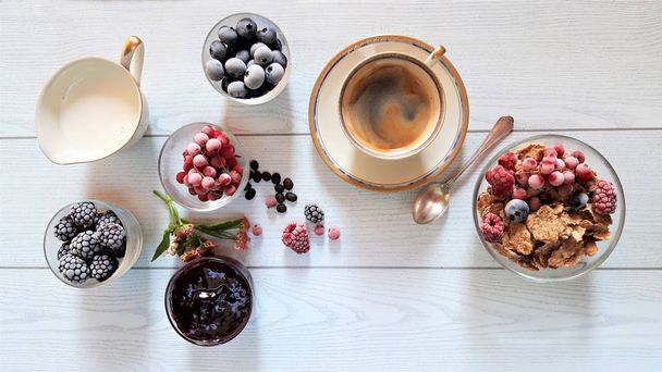 breakfast cereal with berries and coffee served on white table - Photo, Image