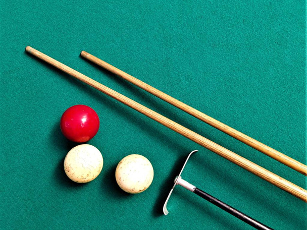 billiard cues, balls and picking tool on green surface - Photo, Image
