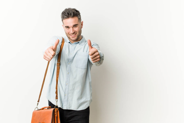 Young handsome business man with thumbs ups, cheers about something, support and respect concept. - Fotoğraf, Görsel