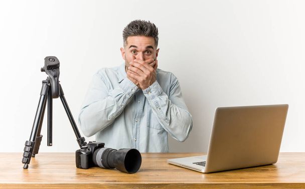 Young handsome photography teacher shocked covering mouth with hands. - Foto, Bild