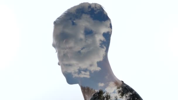 Portrait of pensive man and clouds in the sky - Double exposition - Footage, Video