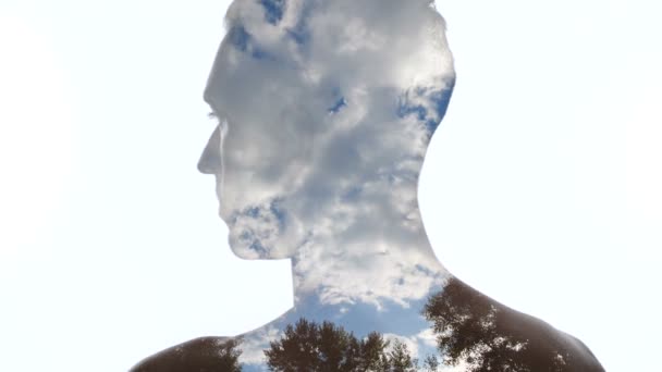 Portrét zamyšlovitého muže a mraků na obloze-dvojitá expozice - Záběry, video