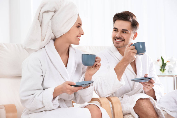 Romantic young couple with tea in spa salon - Foto, afbeelding