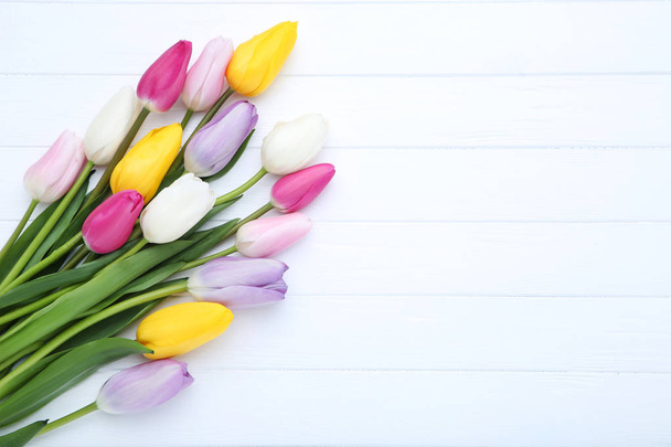 Bouquet of tulip flowers on white wooden table - Фото, зображення