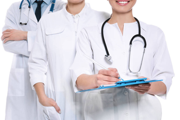 Doctor with clipboard and colleagues on white background, closeup. Unity concept - Foto, Bild
